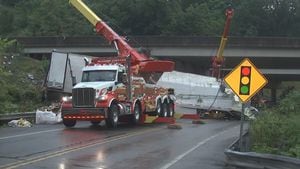 Semi-truck crashes into Parkway North barrier, rolls over onto road below, police say