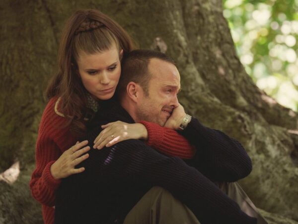 Kate Mara comforts a crying Aaron Paul in the woods in Black Mirror: Beyond The Sea.