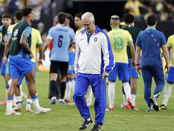 Brazil manager Dorival Junior pictured (centre) looking dejected on Saturday night after his team were knocked out of the Copa America following a penalty-shootout defeat by Uruguay