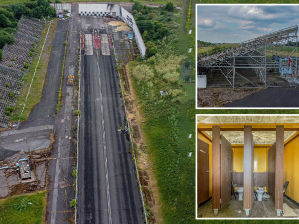 Inside abandoned race track left to rot with weeds growing in grandstand and start lines still in tact