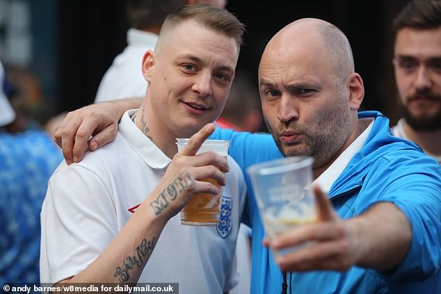 Three Lions supporters are nursing hangovers today after partying into the early hours following the team's breathtaking win over the Netherlands last night. Pictured are England Fans at Box Park Croydon, out for a drink at the box park in Croydon