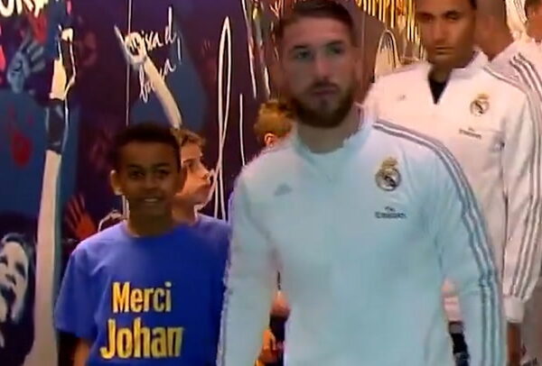 Nine-year-old Lamine Yamal holds hands with Sergio Ramos as mascot